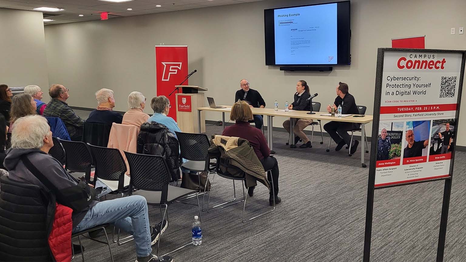 Image of professors sitting at a conference