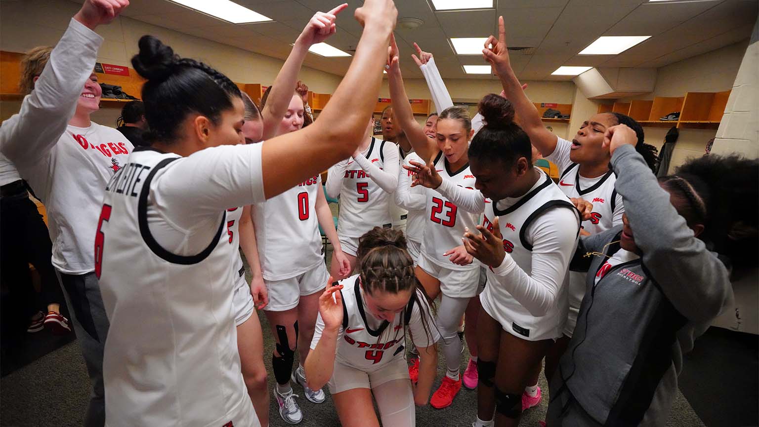 Image of student-athletes celebrating after a Women's Basketball game.