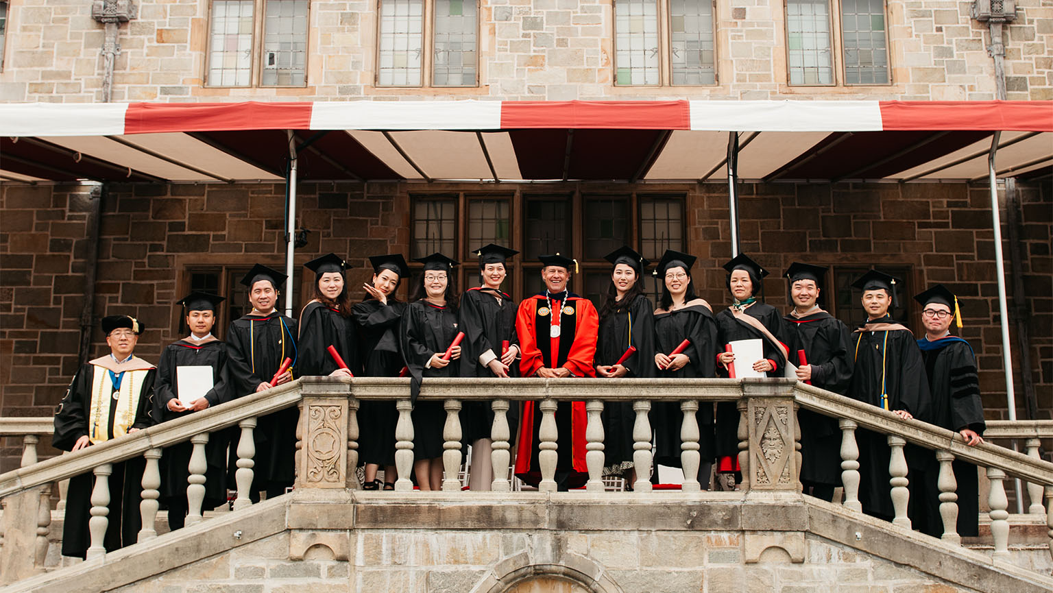 University President Mark R. Nemec, PhD (center), Fairfield Dolan Dean Zhan Li, DBA (far left), and Dr. Ying Zhang (far right) pose with Shanghai MBA students at Bellarmine Hall.