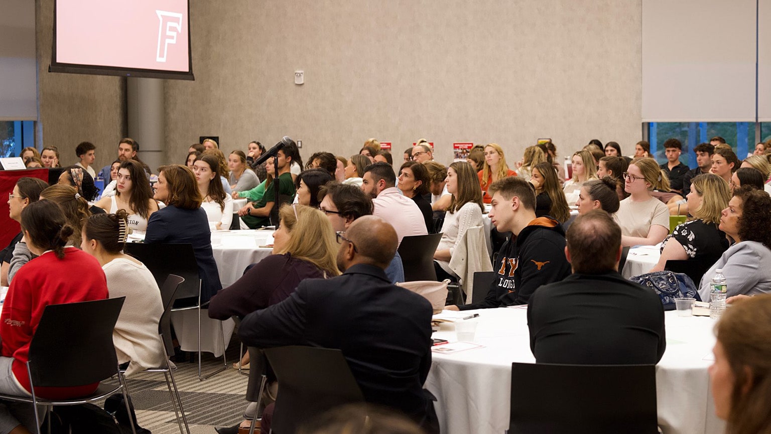 Fairfield students (undergrad and grad) listening intently during a lecture-style event.