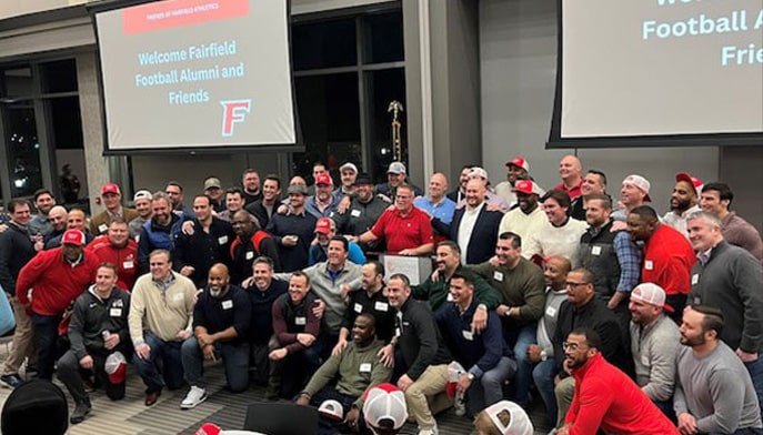 Overhead image of 190+ alumni and families attending an alumni football event.