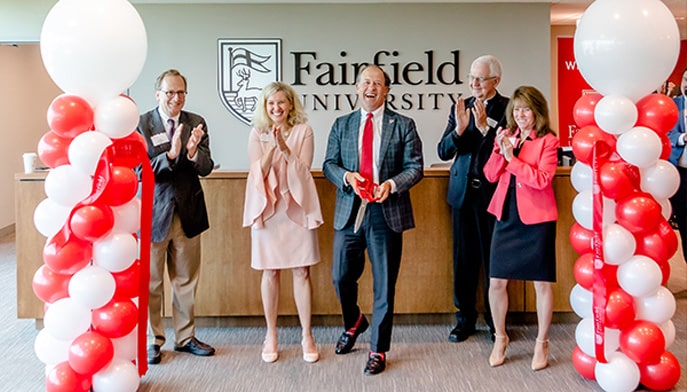 Fairfield University senior leadership members cutting the ribbon at the new Austin, TX campus grand opening.