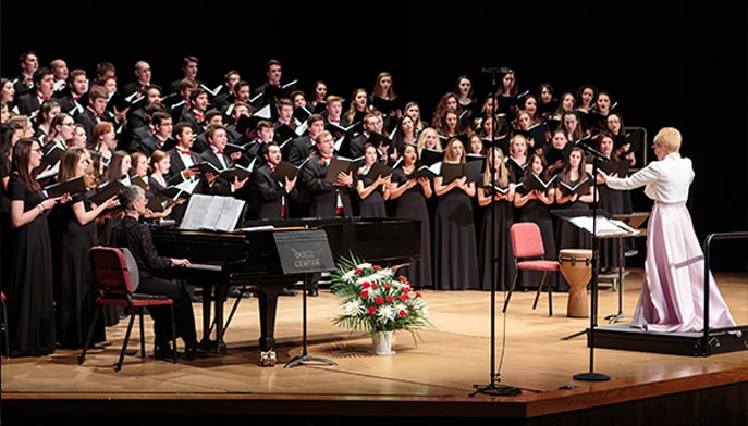 glee club members on stage during a 2018 concert