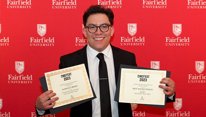 Fairfield film student holding his two Cinefest award certificates. 