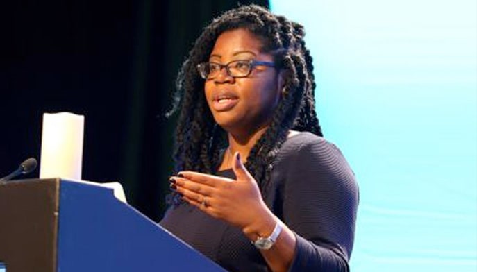 Shannen Dee Williams, PhD speaking at a podium.