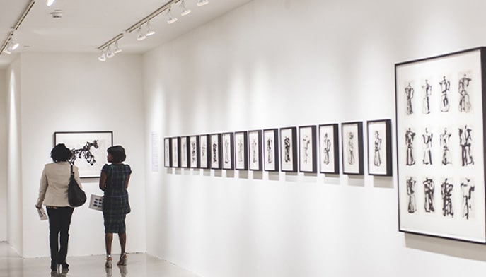 Patrons take in drawings at the Fairfield University Art Museum's Walsh Gallery.