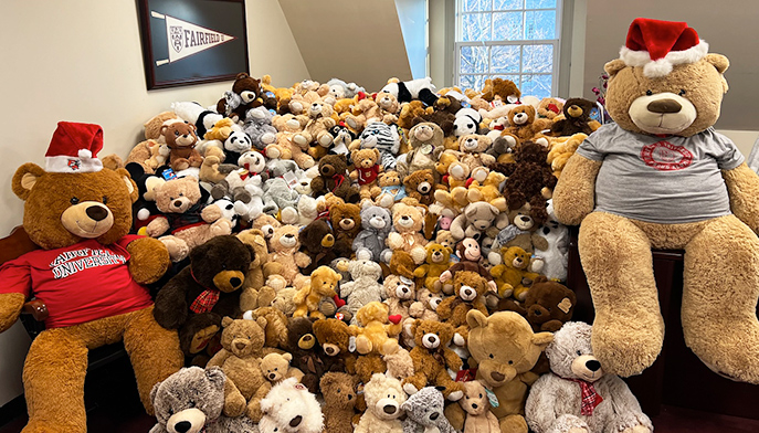 A large pile of assorted teddy bears in various colors and sizes, creating a cozy and inviting display.