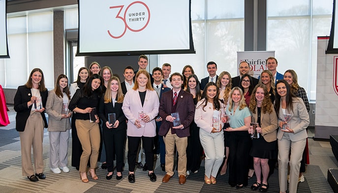 Fairfield Dolan 30 Under 30 award recipients posing as a group with their resin/glass awards.