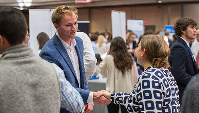 Picture of two people shaking hands at a career fair