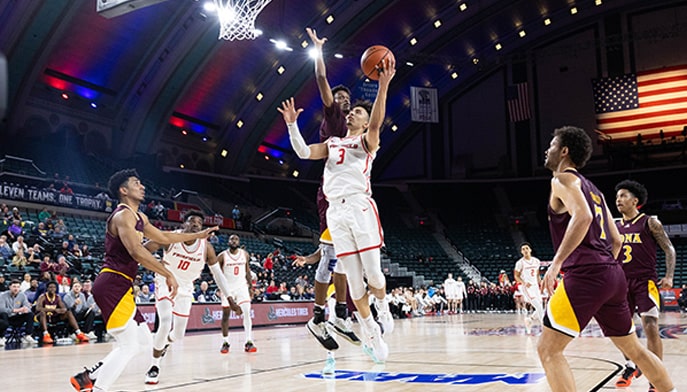 Jalen Leach '24, Men's Basketball player drives to the hole with a layup.