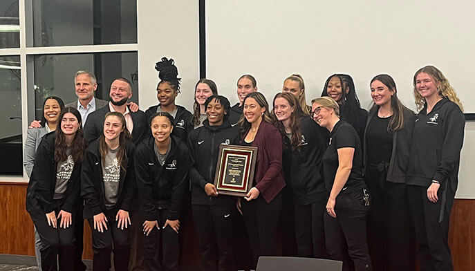 The Fairfield Women's Basketball Team smiles and poses for a group shot with their 2024 Lucy Katz award plaque.