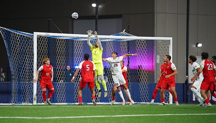 Viktor Nikolov '26 goalie makes a save to preserve a 0-0 draw at #24 UConn at a recent soccer match.