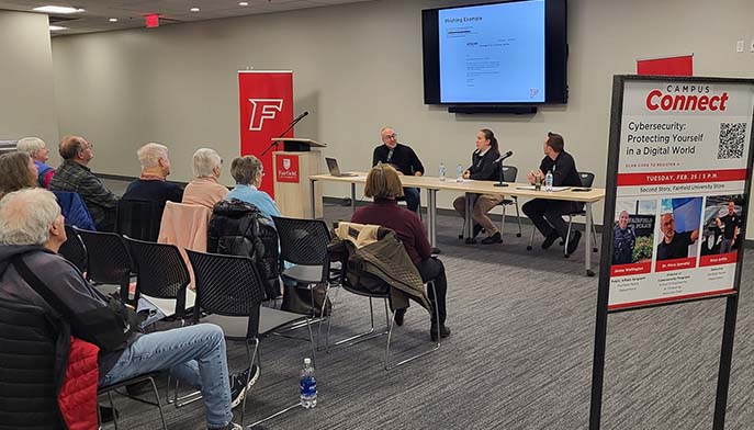 Image of professors sitting at a conference