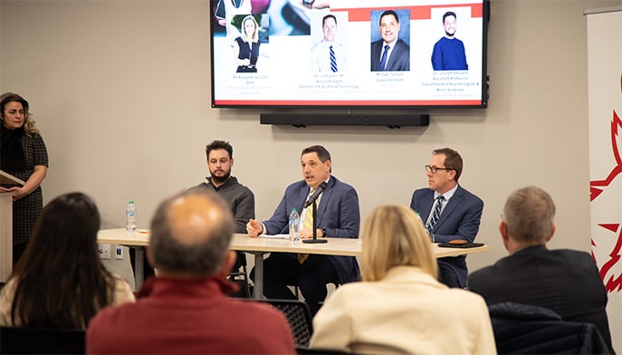 Three panelists engaging the audience in a discussion regarding the effects of screen time on learning and mental health.