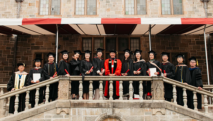 University President Mark R. Nemec, PhD (center), Fairfield Dolan Dean Zhan Li, DBA (far left), and Dr. Ying Zhang (far right) pose with Shanghai MBA students at Bellarmine Hall.