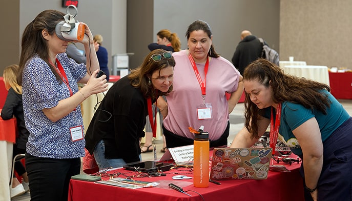 Fairfield alumni Erin Scholes MA’21 demonstrating her research to fellow educators.