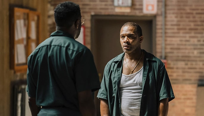 Two black male actors portraying two inmates in a scene from the film Sing Sing.