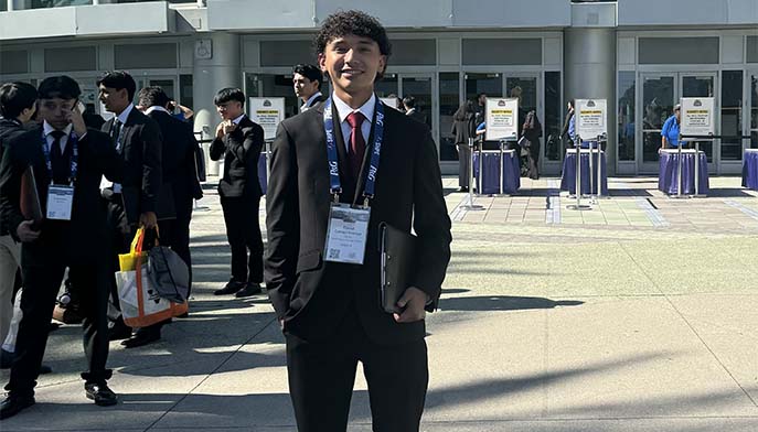 David Camayo Ocampo ’25 stands outside the convention center in Anaheim, CA.