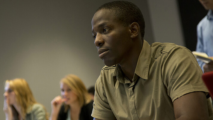 Black studies student listening to a lecture. 