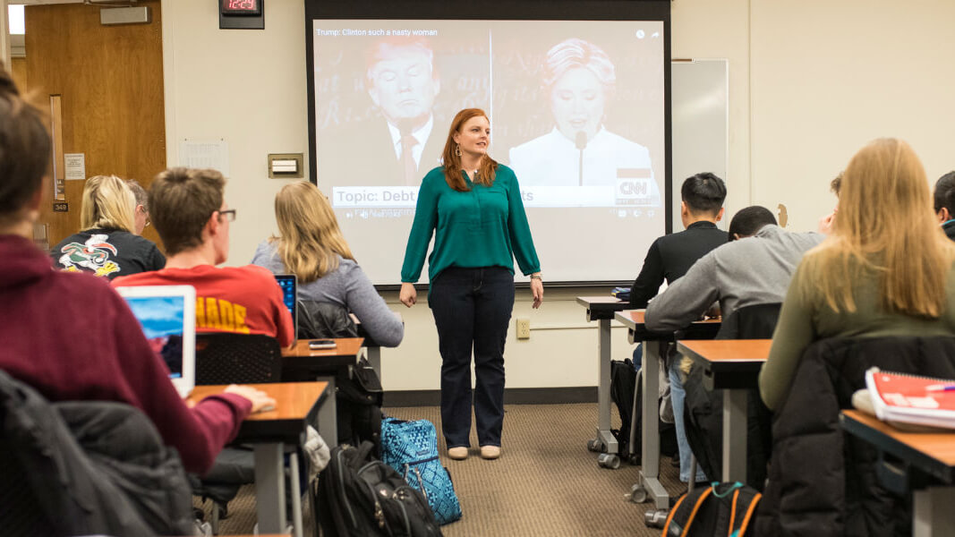 A professor addresses a full classroom.