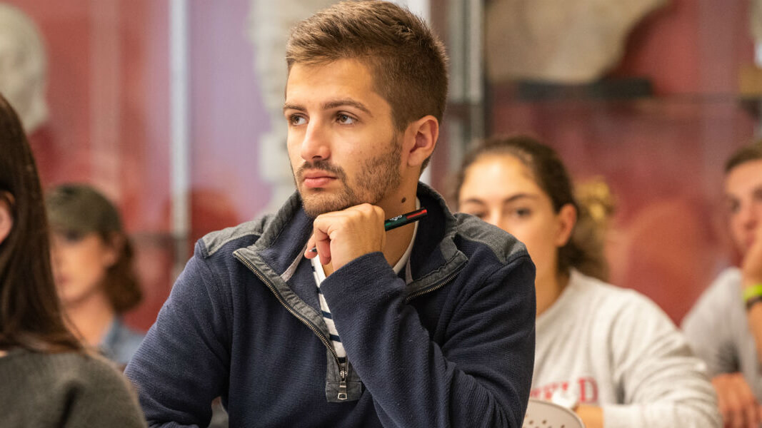 A student sits in a classroom.