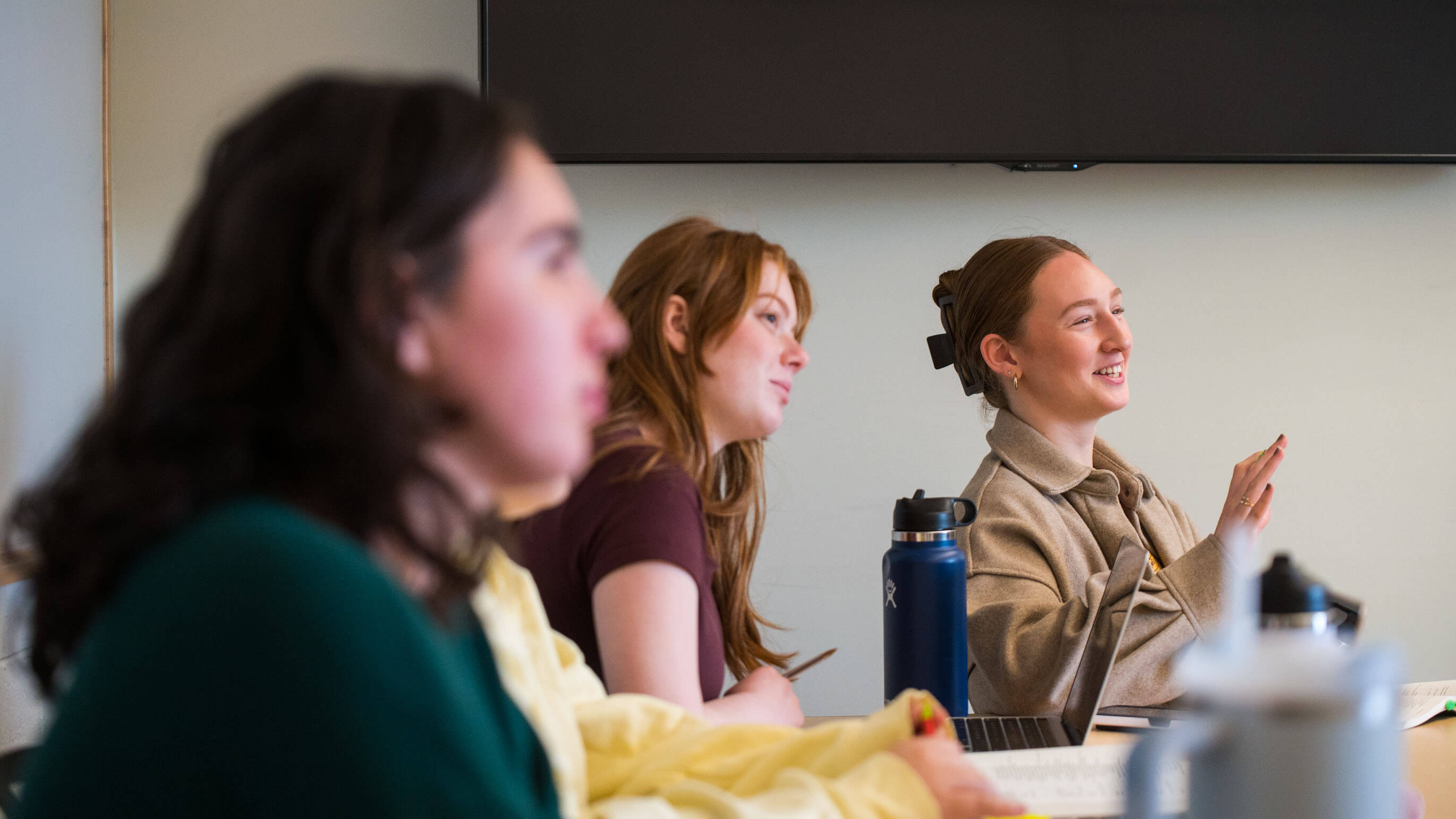 Students talking in a classroom. 