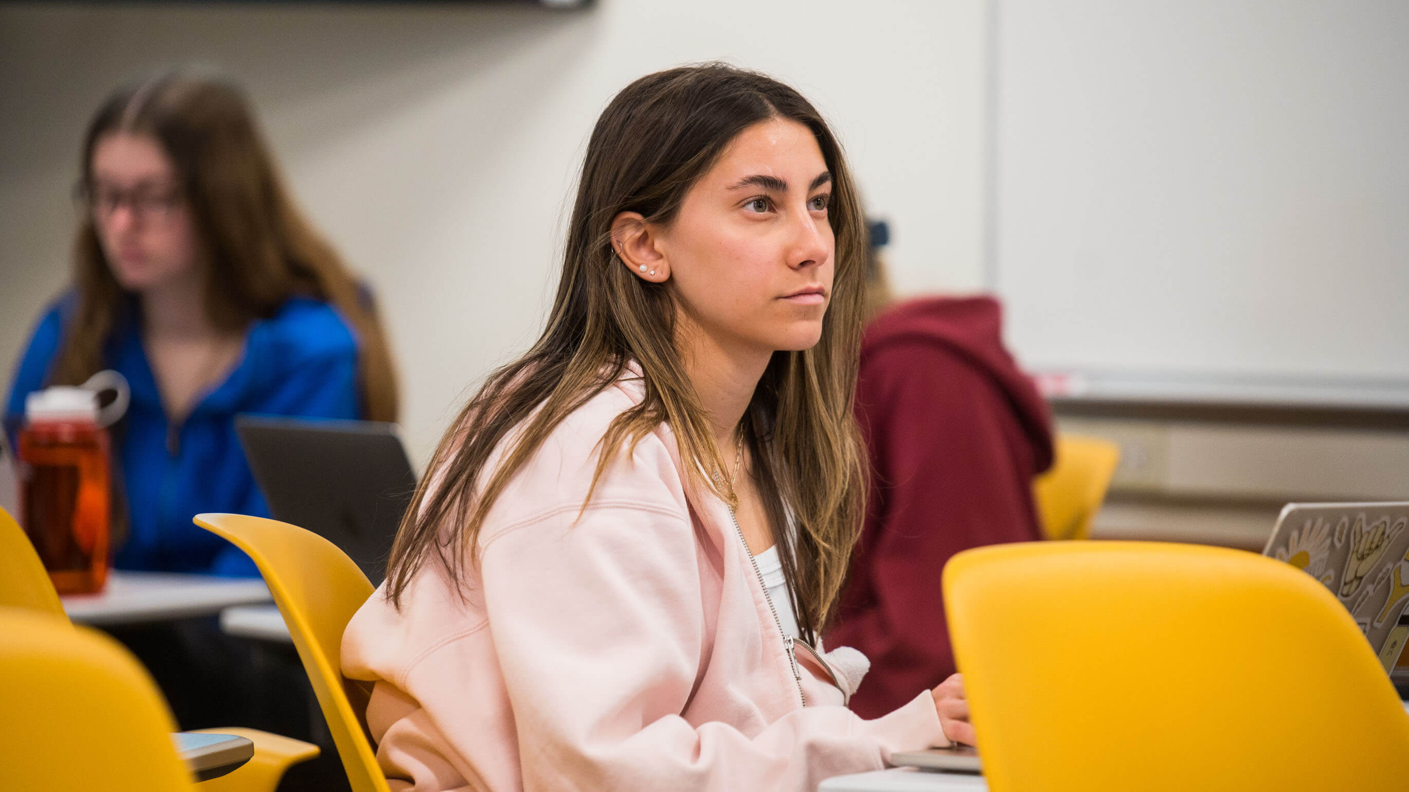 Student paying attention in a classroom. 