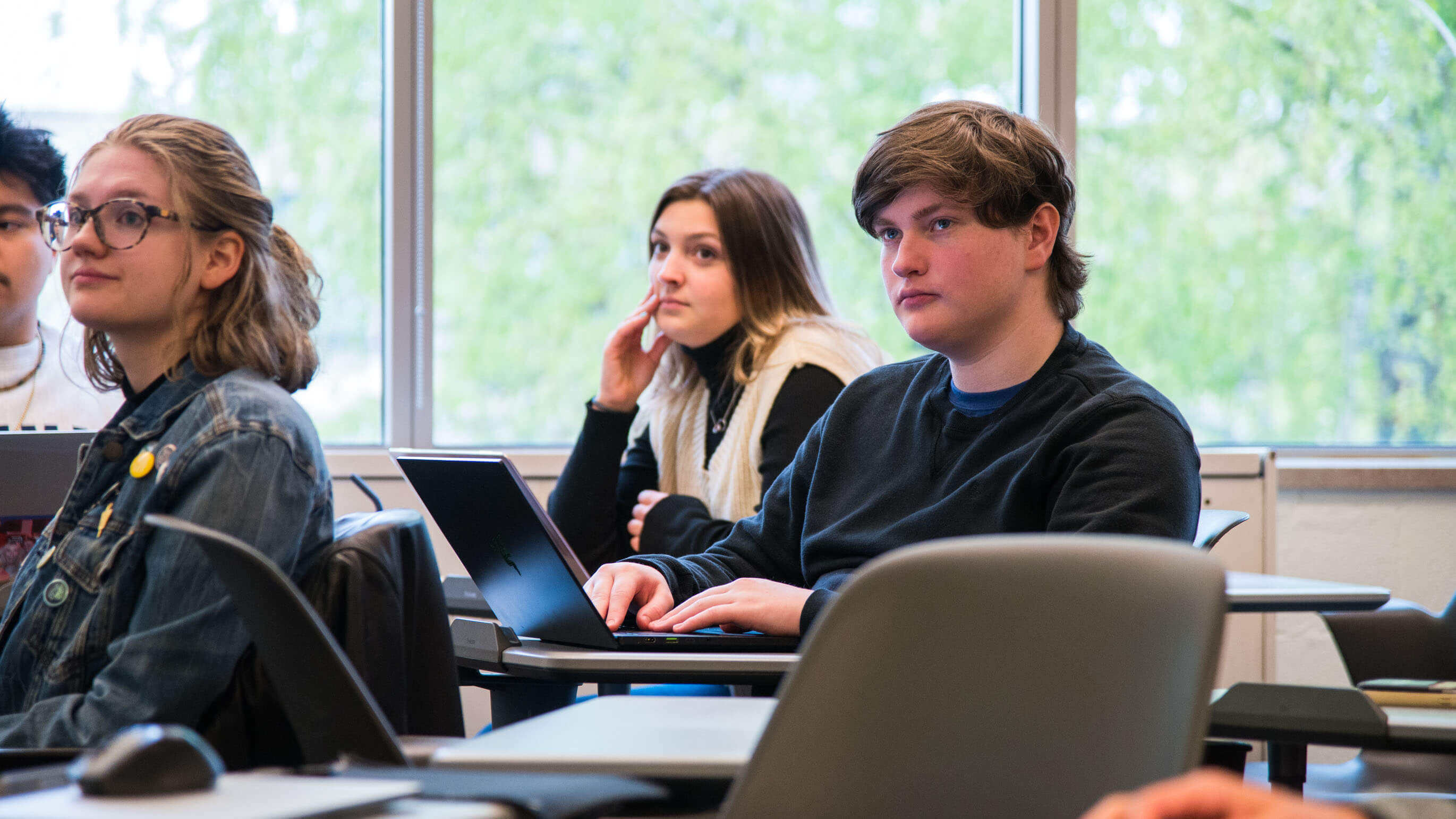 Students in a classroom paying attention. 