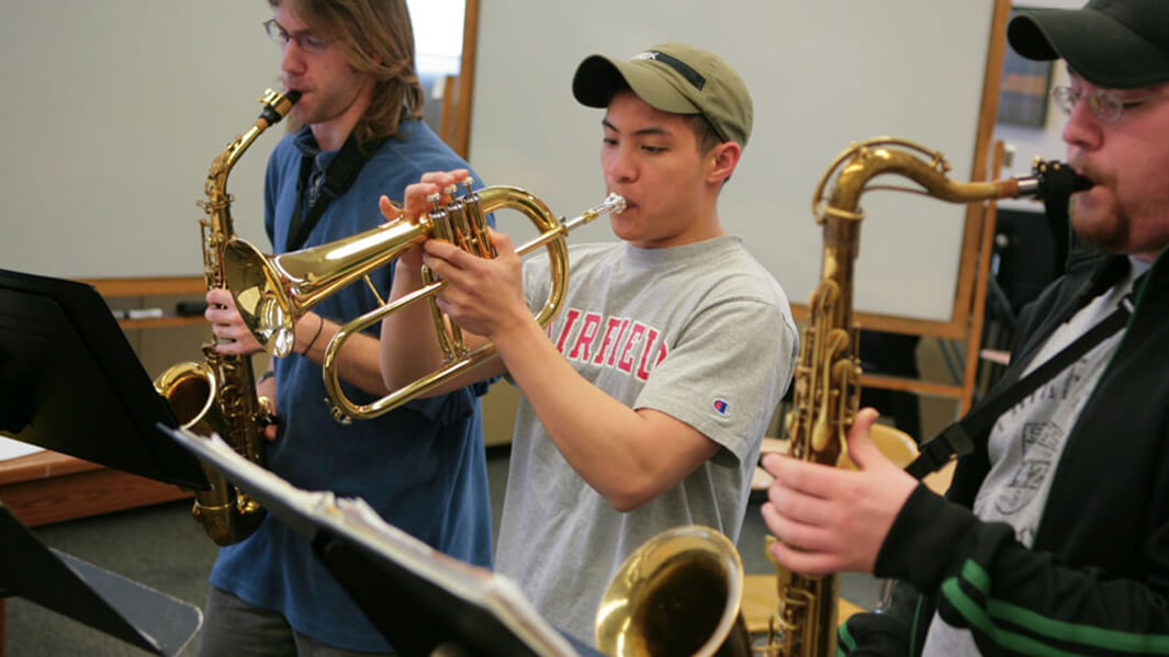 Students playing instruments in a classroom. 