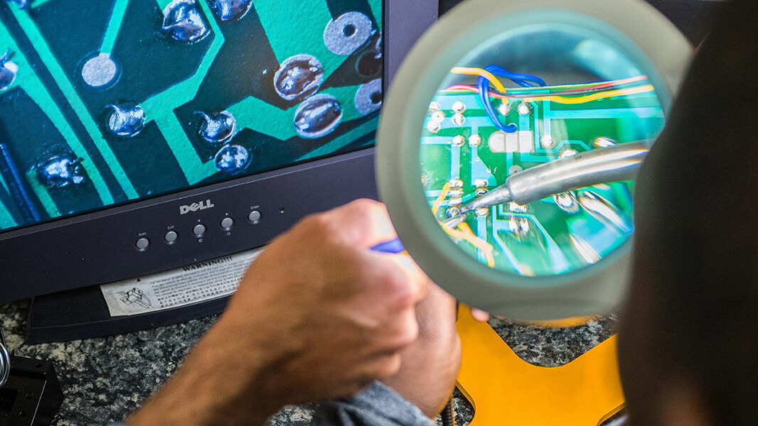 Computer chip being examined under microscope.