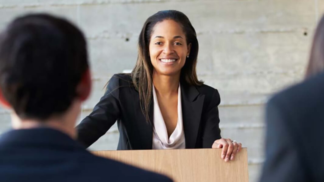 Two students sit at a table.