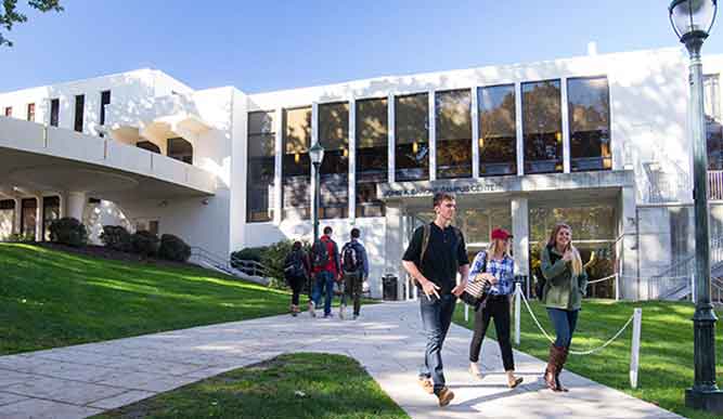 Exterior of Barone Campus Center with students walking on paths.