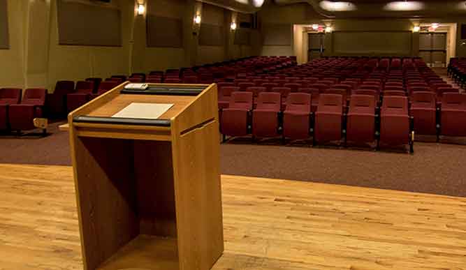 Interior of the Gonzaga Auditorium with podium in foreground.