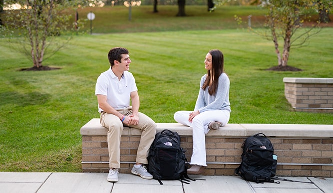 Two Dolan students sitting and talking.