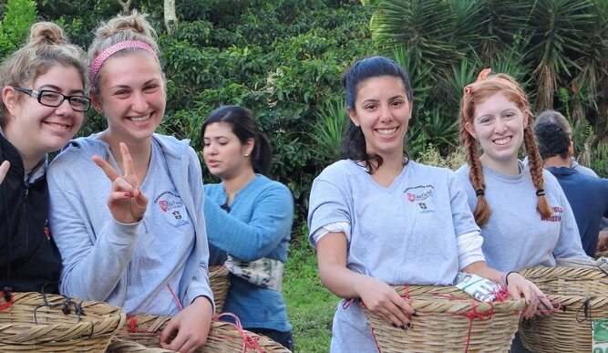 A group of students hold baskets outdoors.