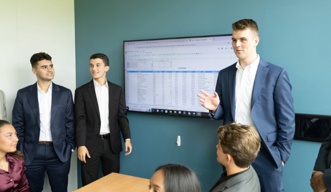 A group of students collaborate in a classroom setting.