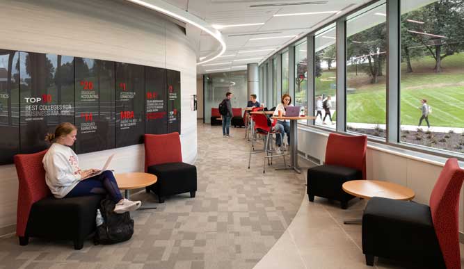 Student studying in the hallways of the Charles F. Dolan School of Business.