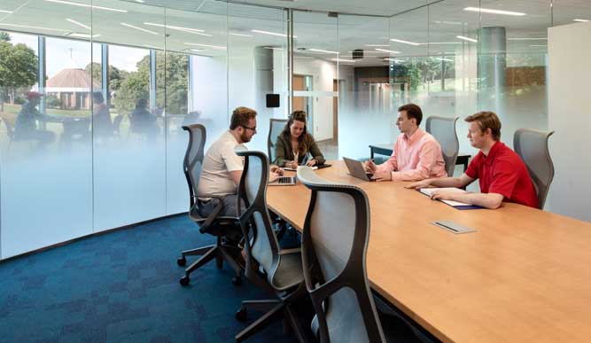 Student working together on a project in one of the Dolan School of Business meeting rooms.