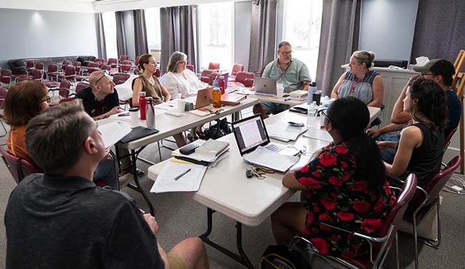 Students sitting in a writing workshop together. 