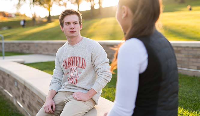 Image of students sitting outside