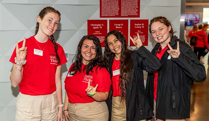 Image of students posing behind a table