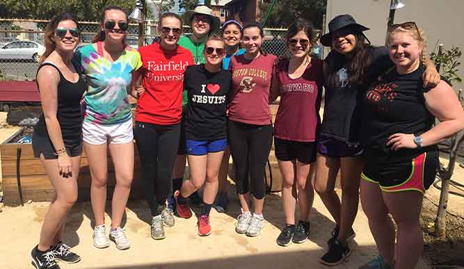 A group of students stands outdoors.