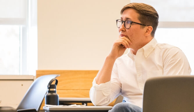 A student sits at a desk.