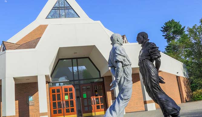 Photo of the Examen statue in front of Egan Chapel.