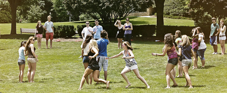 Image of Fairfield University students playing 'elbow tag' outside