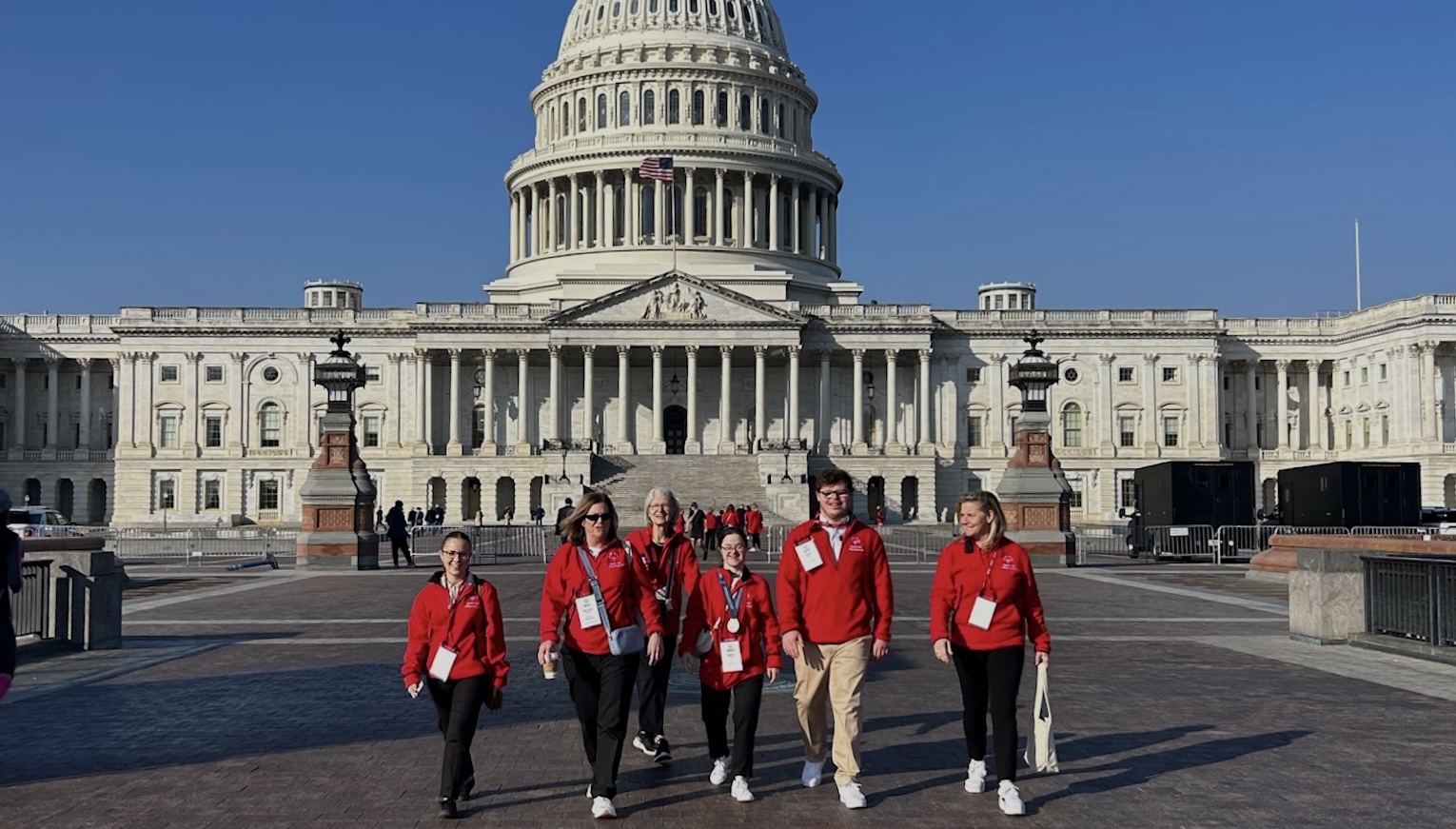 Group of people walking outside of the Capitol. 