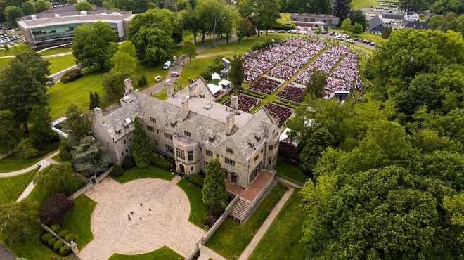 Aerial view of Bellarmine Hall and back lawn during a Commencement ceremony. 