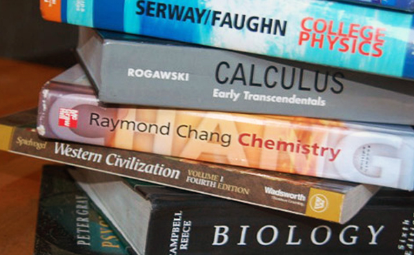 A stack of five random text books.
